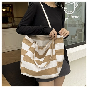 Brown and white striped canvas tote bag shown on a model for daily lifestyle use