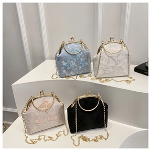 Detail of four retro Chinese style bags with delicate butterfly embroidery and metal handles