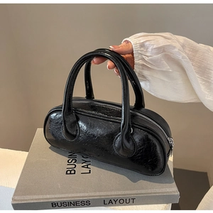 Detailed view of the black glossy textured bowling bag with vintage polished finish