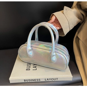Detailed macro shot of holographic silver bowling bag with textured crinkle leather effect