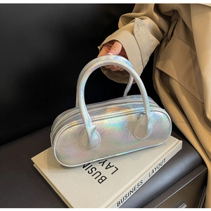 Close-up of holographic silver mini bowling bag with metallic rainbow reflection texture