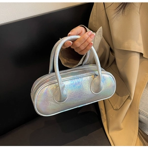 Detail of silver iridescent bowling bag with 23.5 PARIS logo and metallic texture