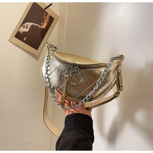 Detail of metallic gold crescent bag with textured leather and silver chain strap