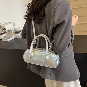 Silver laser metallic bowling handbag with crossbody strap shown in a lifestyle setting