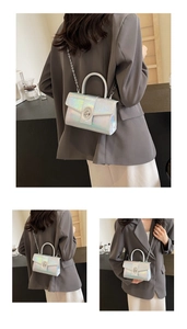 Close-up of holographic silver crossbody bag featuring a metallic twist lock and chain strap
