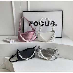 Detail of minimalist underarm bags in four colors with pearl and heart charms