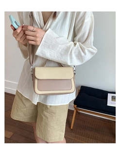 Detail of mixed-material crossbody bag with smooth leather and woven texture details