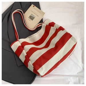 Close-up of red and white striped canvas tote bag texture with high capacity structure