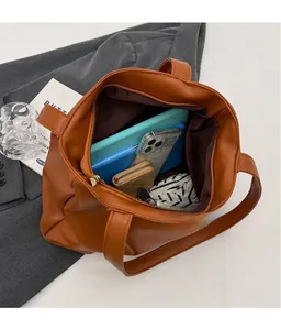 Top view of brown large tote bag showing spacious interior with storage for tablets and gadgets