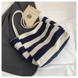 Close-up of blue and white striped canvas tote bag with thick cotton rope handles