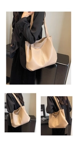 Close-up of beige litchi pattern leather texture and shoulder strap on large tote bag