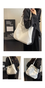 Detailed view of a white minimalist PU leather tote bag with wide shoulder straps