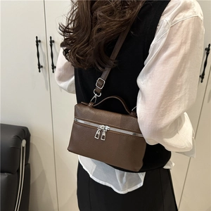Minimalist brown lychee leather handbag with silver double zippers and adjustable strap