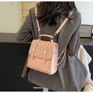 Detail of pink woven texture backpack with metal buckle closure and fine leather straps