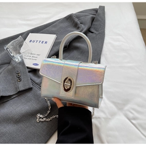 Detail of silver holographic crackle texture bag with metallic oval turn-lock closure