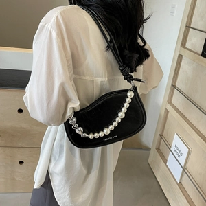 Minimalist black leather underarm bag with pearl chain and silver heart buckle