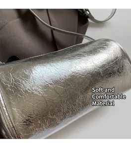 Close-up of metallic silver pillow bag with pleated texture and cylinder shape