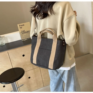 Dettaglio della borsa tote in tela multivariante con tracolla regolabile in grigio scuro