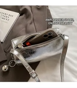 Interior view of silver metallic cylindrical bag showing storage for phone and makeup
