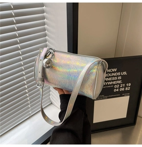 Detail of silver laser cylindrical bag with crackle texture and spherical pendant