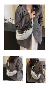 Detail showing the knotted strap and metallic silver crescent bag on a model