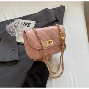 Detail of pink quilted mini bag showing gold chain strap and adjustable ball charm