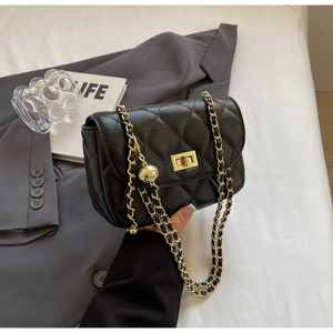 Detail of black quilted chain bag with gold hardware and square twist lock closure