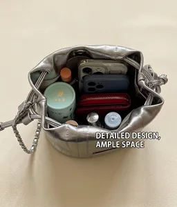 Spacious interior of silver drawstring bucket bag showing storage for phones and wallet