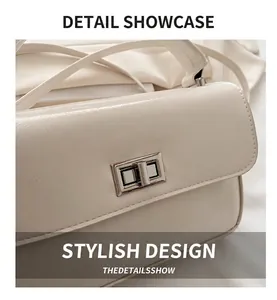 Close-up of cream textured leather handbag featuring a silver rectangular twist lock closure