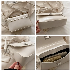 Detail view of white square crossbody bag showing back, side, bottom and interior storage