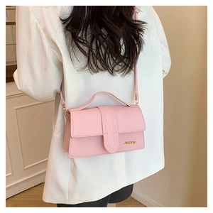 Pink textured crossbody bag with gold JINGPIN lettering and elegant top handle strap