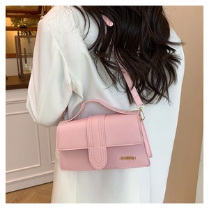 Detailed back view of pink PU leather crossbody bag showing size and fit on model