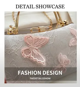 Detail of floral lace evening bag with 3D butterfly embroidery and pearl handle