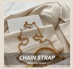 Close-up of elegant floral jacquard fabric with sparkling rhinestone bow clasp and gold chain