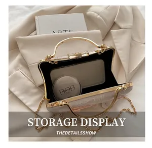 Detail showing inner capacity of embroidered evening bag with smartphone and makeup
