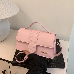 Elegant pink leather crossbody bag with top handle and golden JINGPIN logo detail