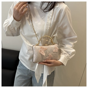 Detailed embroidery of 3D butterfly appliqué on pink fabric dinner handbag