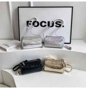 Detail of four metallic cylinder bags with crushed texture and round zip pendant