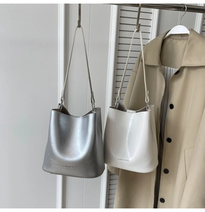 Détails des sacs seaux argent et crème avec texture craquelée et logo Fashion & Bags