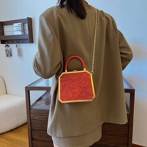 Vintage red hexagonal box bag with floral embossing and gold chain shoulder strap