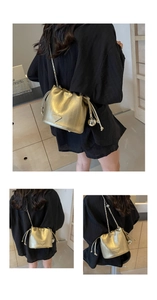 Detail of gold metallic bucket bag with drawstring closure and chain strap