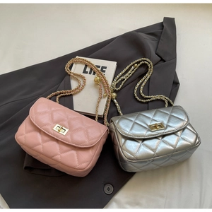 Detailed close-up of quilted mini chain bags in pink and silver with metal ball adjusters