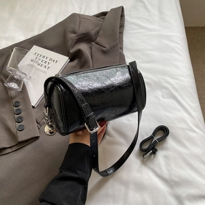 Minimalist black pillow crossbody bag with pleated texture and silver ball charm decoration