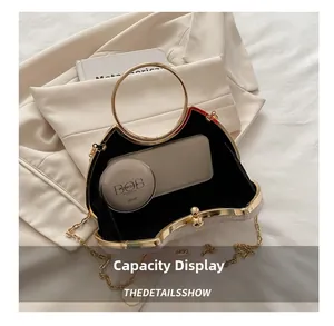 Detail view of cream crocodile leather box bag interior holding phone and powder