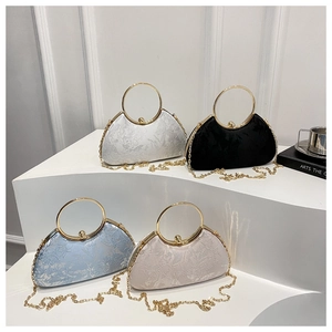 Detailed view of elegant evening clutch bags in four colors with pearl clasp and metal handle