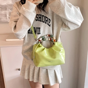 Light green pleated cloud bucket bag with crocodile pattern and beaded handle