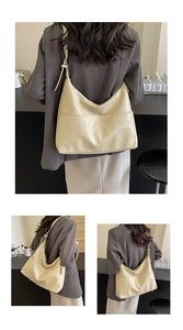 Detailed view of the creamy white Hobo tote with textured faux leather and adjustable strap