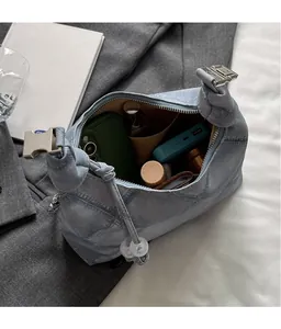 Top view of spacious light blue denim bag interior holding daily essentials and accessories