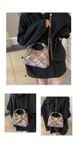Detail of vintage brown quilted leather texture with metallic ring handle and chain strap