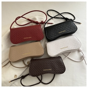 Macro shot of minimalist woven texture bags in five colors with gold fashion logo